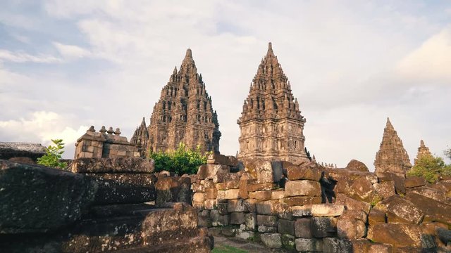 Prambanan temple stone brick piles in Jogjakarta, Indonesia on sunny evening, slide right