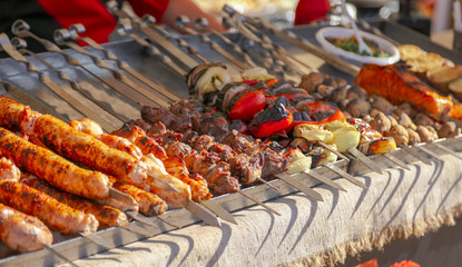 Grilled kebabs on metal sticks in nature