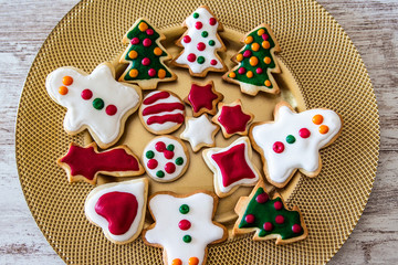 Fototapeta na wymiar Christmas cookies on a dish with a wooden table background