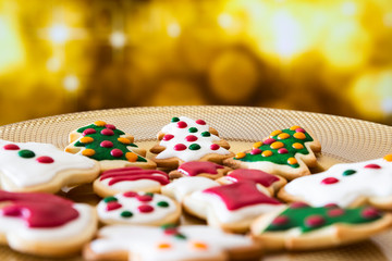 Christmas cookies on a dish with golden lights background