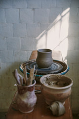 selective focus of clay pot on pottery wheel at workshop