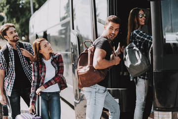 Group of Young People Boarding on Travel Bus © VadimGuzhva