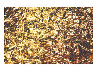 Golden crumpled foil texture isolated on white background