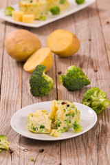 Potato gratins with broccoli florets.