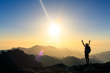 Woman hiking success silhouette in mountains sunset - 230599542