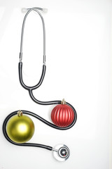 Celebrating Christmas in the healthcare industry. Top view of flat lay. Stethoscope with ornaments...
