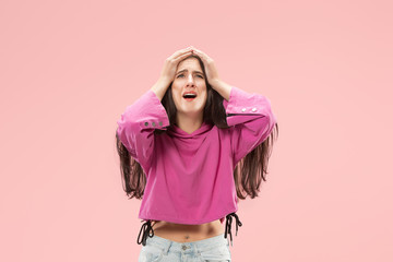 Why is that. Beautiful female half-length portrait isolated on trendy pink studio backgroud. Young emotional surprised, frustrated and bewildered woman. Human emotions, facial expression concept.