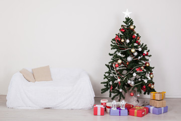 Christmas tree in the room with Christmas decorations and gifts toys