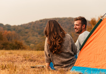 Young couple on a camping holiday enjoying time together.