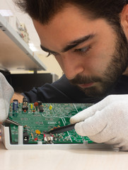 A technician working on a PCB board