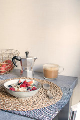 Healthy breakfast concept - oatmeal with ripe berries and cappuccino