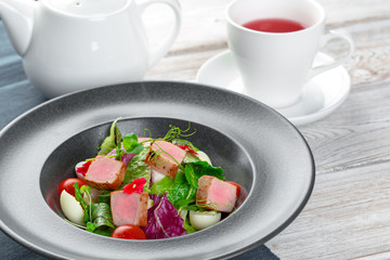 Green salad with cube slices of ham