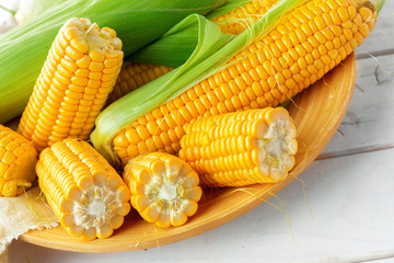 Raw corn on a wooden table