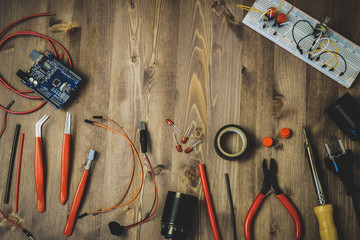 Workplace With Tools: Breadboard, Push Button, Resistors, Tweezers, Nippers, Soldering Iron, Wires, Microcircuit, Lamp Socket. Electronics Repair Service. Concept of Electronics, Programming.