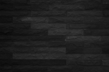 Seamless Black pattern of decorative brick sandstone wall surface with concrete of modern style design decorative uneven have cracked realmasonry wall of multicolored stones or blocks with cement.