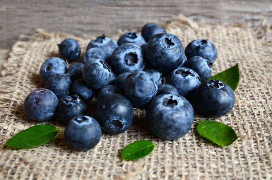 Freshly picked organic blueberries on a burlap cloth background.Blueberry. Bilberries.Healthy eating,vegan food or diet concept.Selective focus.
