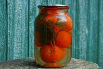 canned red tomatoes in a marinade glass jar