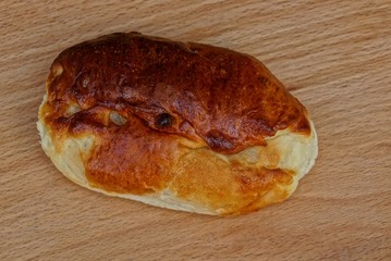 one fried patty lies on a brown wooden board