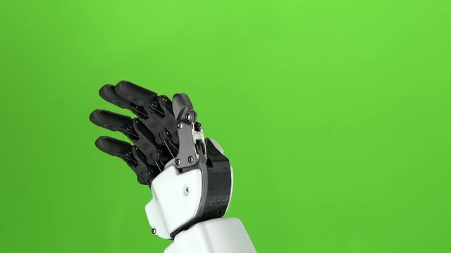 Robot hand close up waving hi . Green screen. Slow motion