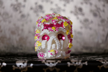 A Calavera is a representation of a human skull and made from either sugar and are decorated with colored foil and icing which is used in the Mexican celebration of the Day of the Dead.