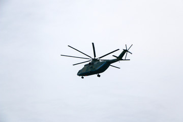 Fototapeta na wymiar a large military helicopter hovers in the sky. A camouflaged helicopter flies at high speed.