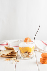 Lemon dessert, cheesecake, whipped cream, parfait. Fruit mousse in glass on a light background.