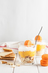 Tiramisu, variant of traditional Italian creme dessert for children with macaroons and mascarpone cheese on white background.
