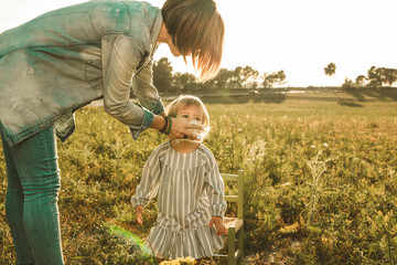 A mother wiping a child's mouth
