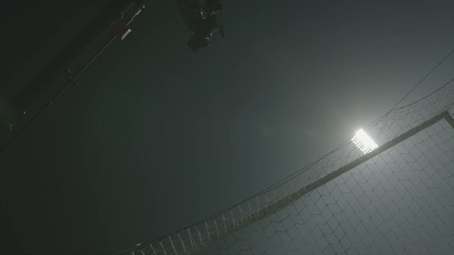 Camera crane behind net