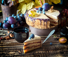 Autumn composition with a slice of cream cake with chocolate and nuts, rustic