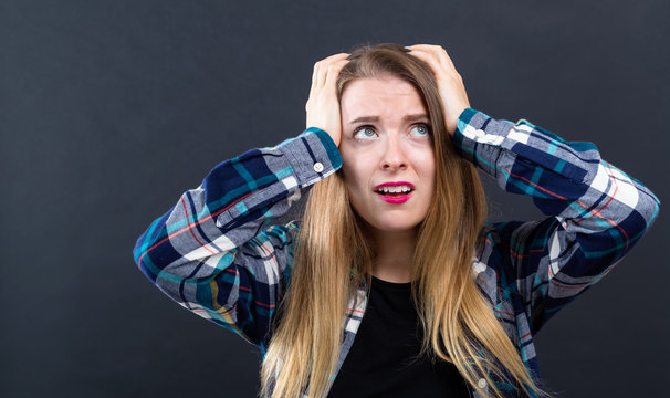 Young Woman Feeling Stressed On A Black Background