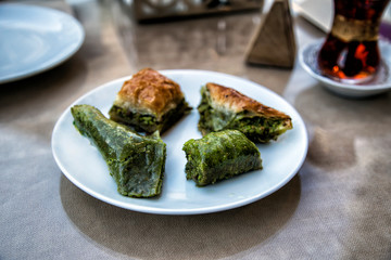 Mixed baklava and sobiyet in white plate . Ramadan food, turkish arabian cuisine. Selective focus