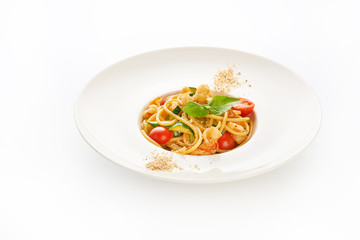 Spaghetti with shrimps, cherry tomatoes, zucchini and basil on white background