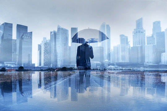insurance concept, risk in business, businessman with umbrella double exposure