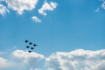 A group of military aircraft perform aerobatics
