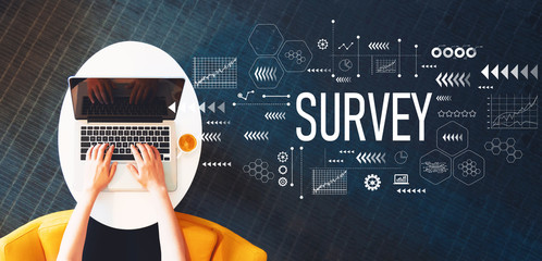 Survey with person using a laptop on a white table