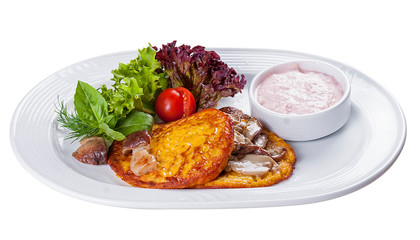 Pancakes with pumpkin and porcini mushrooms on a white plate