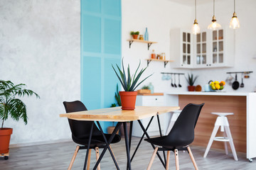 Stylish kitchen interior with dining table and chairs