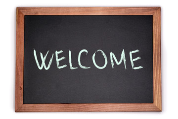 Obraz premium WELCOME sign written on chalk board. Blackboard with wooden frame.
