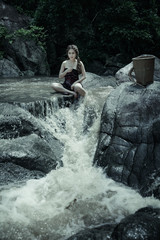 Fototapeta na wymiar Young asian girl lady sexy and smiling relaxation sit bathing in a natural forest waterfall 