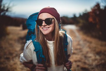 young woman hiking on the beautiful sunny autumn day
