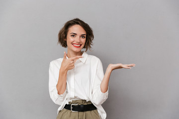 Portrait of a cheerful young woman presenting copy space