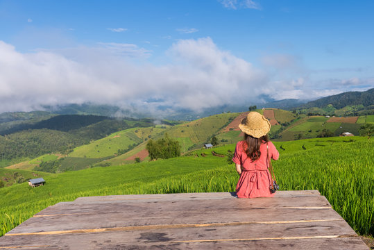 Young woman relaxing in green rice terraces on holiday at pabongpaing village, Mae-Jam Chiang mai, Thailand