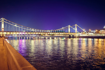 Fototapeta na wymiar The long beautiful bridge across the river in the evening.