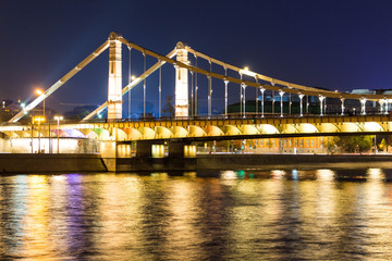 Obraz premium The long beautiful bridge across the river in the evening.