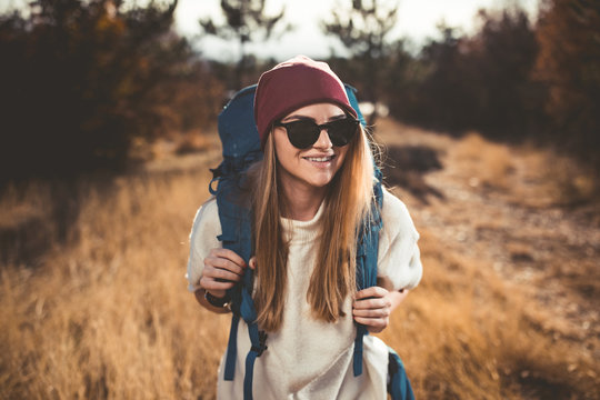 young woman hiking on the beautiful sunny autumn day