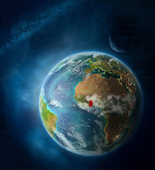 Obraz na płótnie Canvas Ghana from space on Earth surrounded by space with Moon and Milky Way. Detailed planet surface with city lights and clouds.