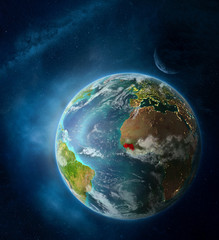 Guinea from space on Earth surrounded by space with Moon and Milky Way. Detailed planet surface with city lights and clouds.