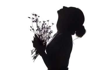 silhouette portrait of a beautiful girl with a bouquet of with dandelions on a white isolated background