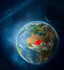Niger from space on Earth surrounded by space with Moon and Milky Way. Detailed planet surface with city lights and clouds.